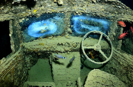 Fish explore a truck on the sunken S S Thistlegorm